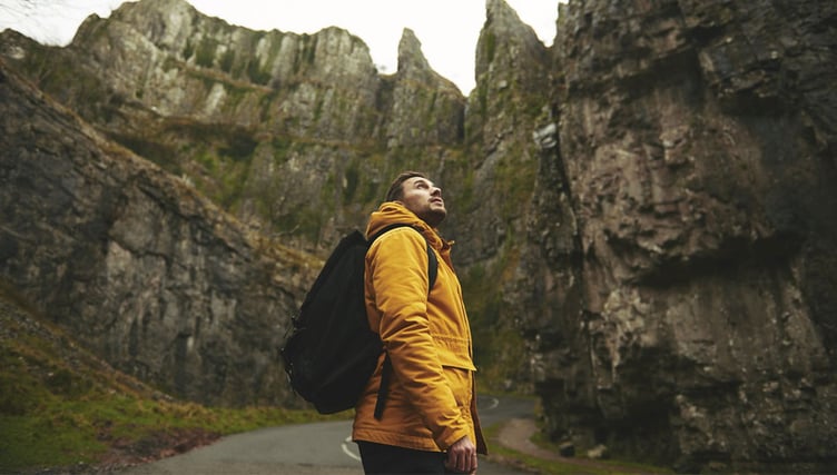 Traveler looking above on road