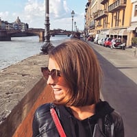 Emily walking along a river in Florence