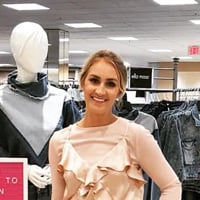 Janissa P. in fashion showroom full of deniem clothing