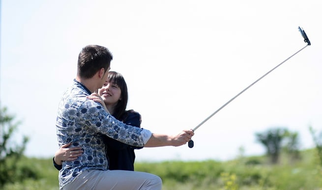 Couple taking picture with selfie stick