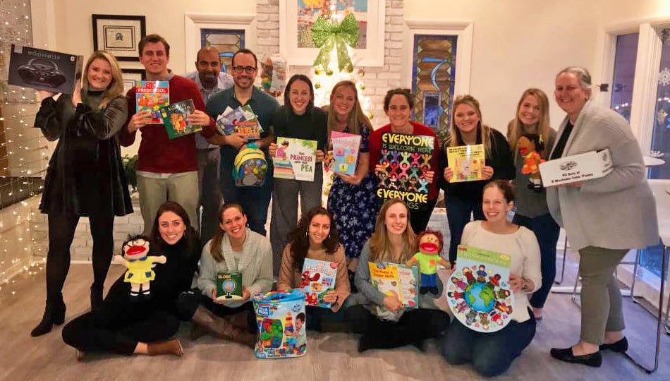 Global Experiences staff with donated-toys