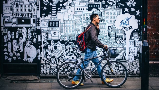 Man Walking his Bike