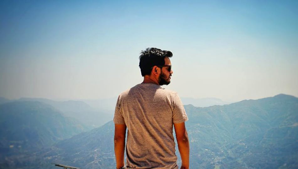 Man standing on top of mountain