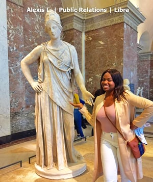 Paris intern next to a statue in the louvre