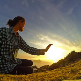 Woman watching the sunrise in New Zealand