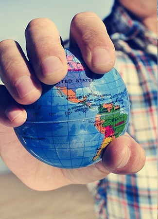 Person holding a hand sized globe 