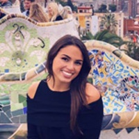 Nathalie G. smiling with the Barcelona skyline behind