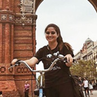 Nicole G. riding a bike through Barcelona