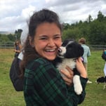 Jaclyn K. holding a black and white puppy