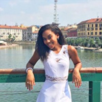 Bryanna W. on a bridge overlooking a river in Milan