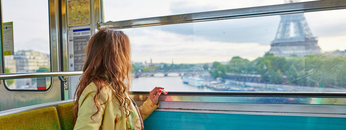 Girl-looking-at-Eiffel-Tower-from-Train