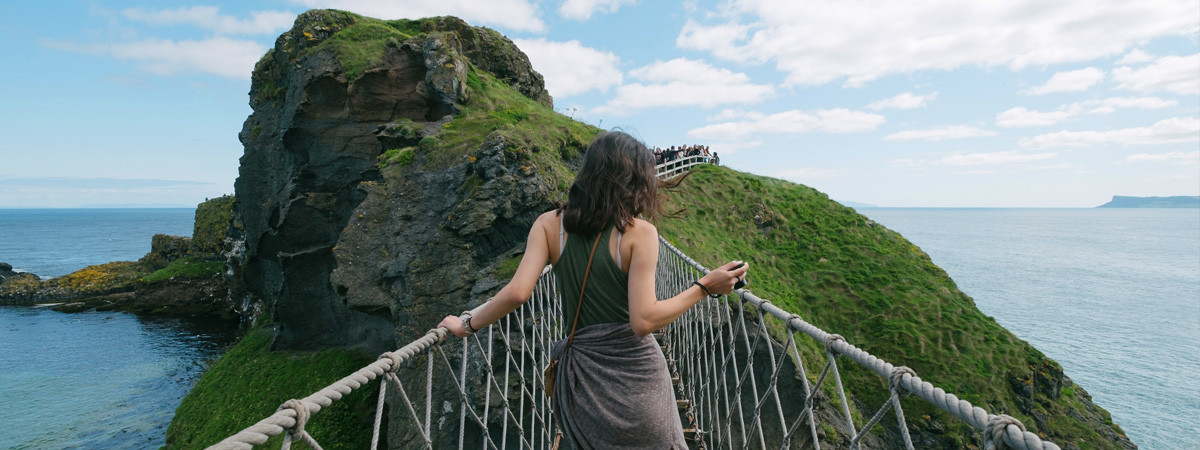 Woman-Walking-Across-the-Carrick-a-Rope-Bridge